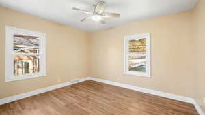 Spare room featuring wood finished floors and ceiling fan
