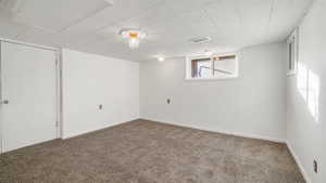Below grade area featuring carpet and baseboards