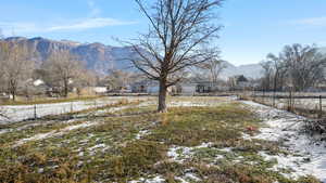 Snowy yard with a mountain view