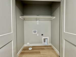 Laundry room with light wood-style floors, washer hookup, and hookup for an electric dryer