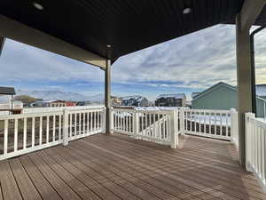 Wooden deck featuring a mountain view and a residential view