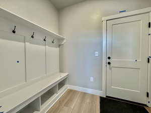 Mudroom with baseboards and light wood-type flooring