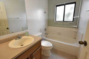 Bathroom with vanity, light tile patterned flooring, and shower / bathtub combination