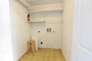 Laundry room with light floors, hookup for a washing machine, and electric dryer hookup