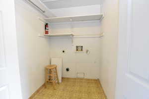 Laundry room featuring light flooring, hookup for a washing machine, and hookup for an electric dryer