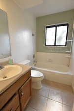 Bathroom featuring vanity, shower / washtub combination, and light tile patterned floors