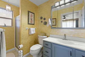 Bathroom featuring plenty of natural light, a stall shower, and vanity