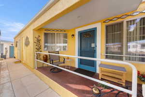 Property entrance featuring stucco siding