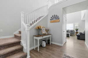 Staircase featuring baseboards and wood finished floors