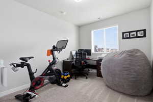 Carpeted office space with baseboards