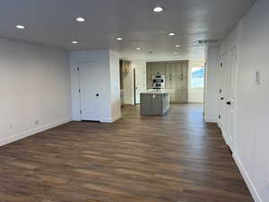 Living area featuring recessed lighting and dark wood-style floors