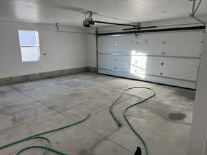 Garage featuring a garage door opener