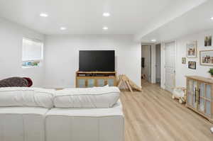 Living area featuring light wood-style flooring and recessed lighting