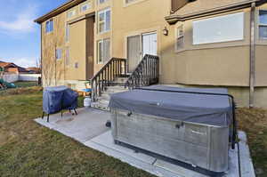 View of patio / terrace with a hot tub and a grill