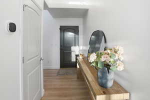 Corridor featuring light wood finished floors and baseboards