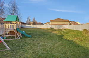 Fenced backyard with a playground