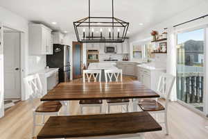 Dining space with light wood-type flooring and recessed lighting