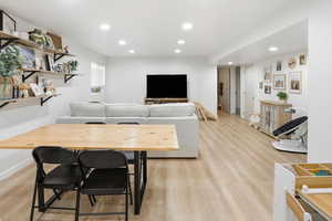 Living room with recessed lighting and light wood-style floors