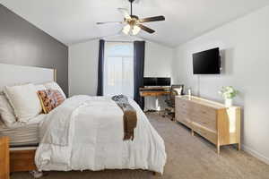 Bedroom with ceiling fan, carpet, lofted ceiling, and a desk