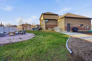 Fenced backyard with a patio area and an outdoor hangout area
