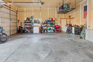 Garage with electric panel and a garage door opener