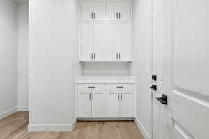 Detailed view of wood finished floors and baseboards