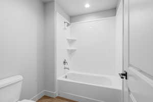 Full bathroom featuring shower / bathtub combination and light wood-type flooring