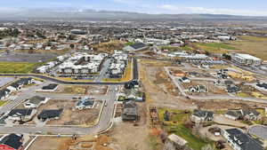 Aerial view of property and surrounding area featuring mountains