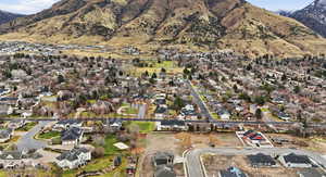 Aerial overview of property's location with nearby suburban area and a mountain backdrop