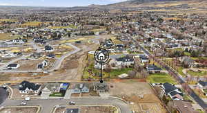 Aerial overview of property's location with nearby suburban area and a mountain backdrop
