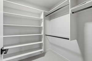 Walk in closet with light carpet