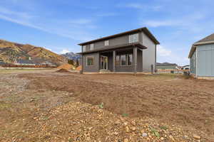 Rear view of property featuring a mountain view and a porch