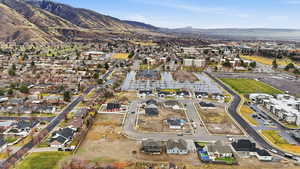 Aerial overview of property's location featuring a mountain backdrop and nearby suburban area