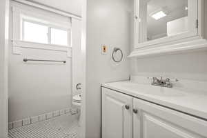 Half bath with vanity and toilet