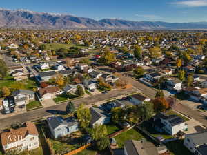 Aerial view of property's location featuring nearby suburban area and mountains