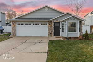 Ranch-style house featuring brick siding, concrete driveway, and an attached garage