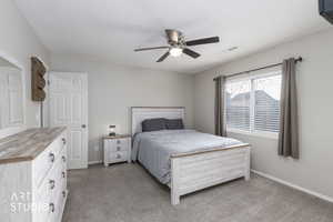 Bedroom featuring light colored carpet and ceiling fan