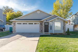 Ranch-style home featuring brick siding, driveway, and a garage