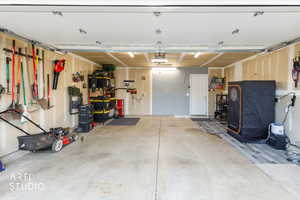 Garage with a workshop area and a garage door opener
