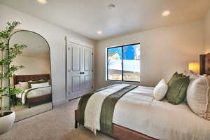 Bedroom with carpet flooring, recessed lighting, and a closet