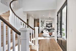 Foyer with light wood-type flooring and recessed lighting