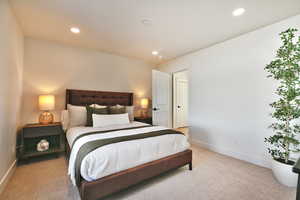 Bedroom featuring light colored carpet and recessed lighting