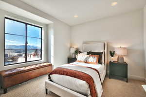 Carpeted bedroom with a mountain view and recessed lighting