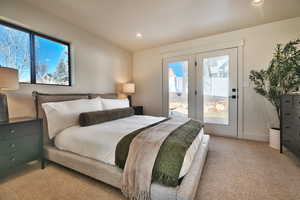 Bedroom featuring light colored carpet, access to exterior, and recessed lighting