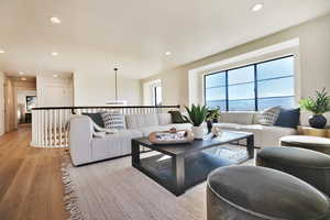 Living area featuring light wood-type flooring and recessed lighting
