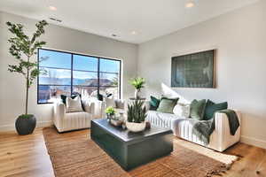 Living room featuring a mountain view, light wood finished floors, and recessed lighting