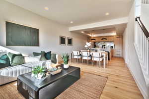 Living area with recessed lighting and light wood-type flooring