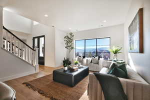 Living area featuring light wood-type flooring, a mountain view, and recessed lighting