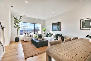 Living area featuring light wood-style floors and recessed lighting