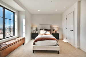 Bedroom featuring light carpet and recessed lighting